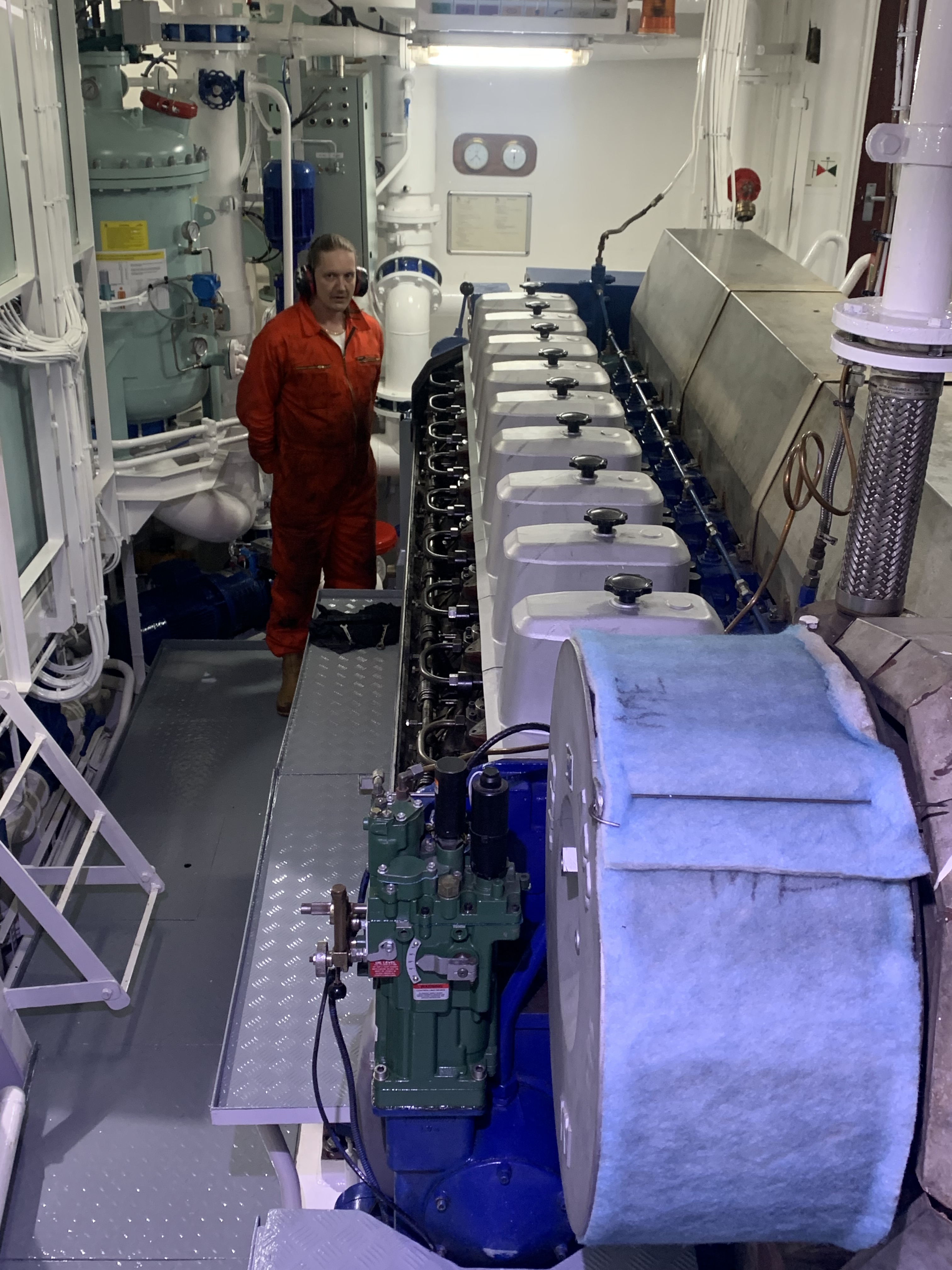 Captain H. standing by the engine as we just restarted it after the maintenance work