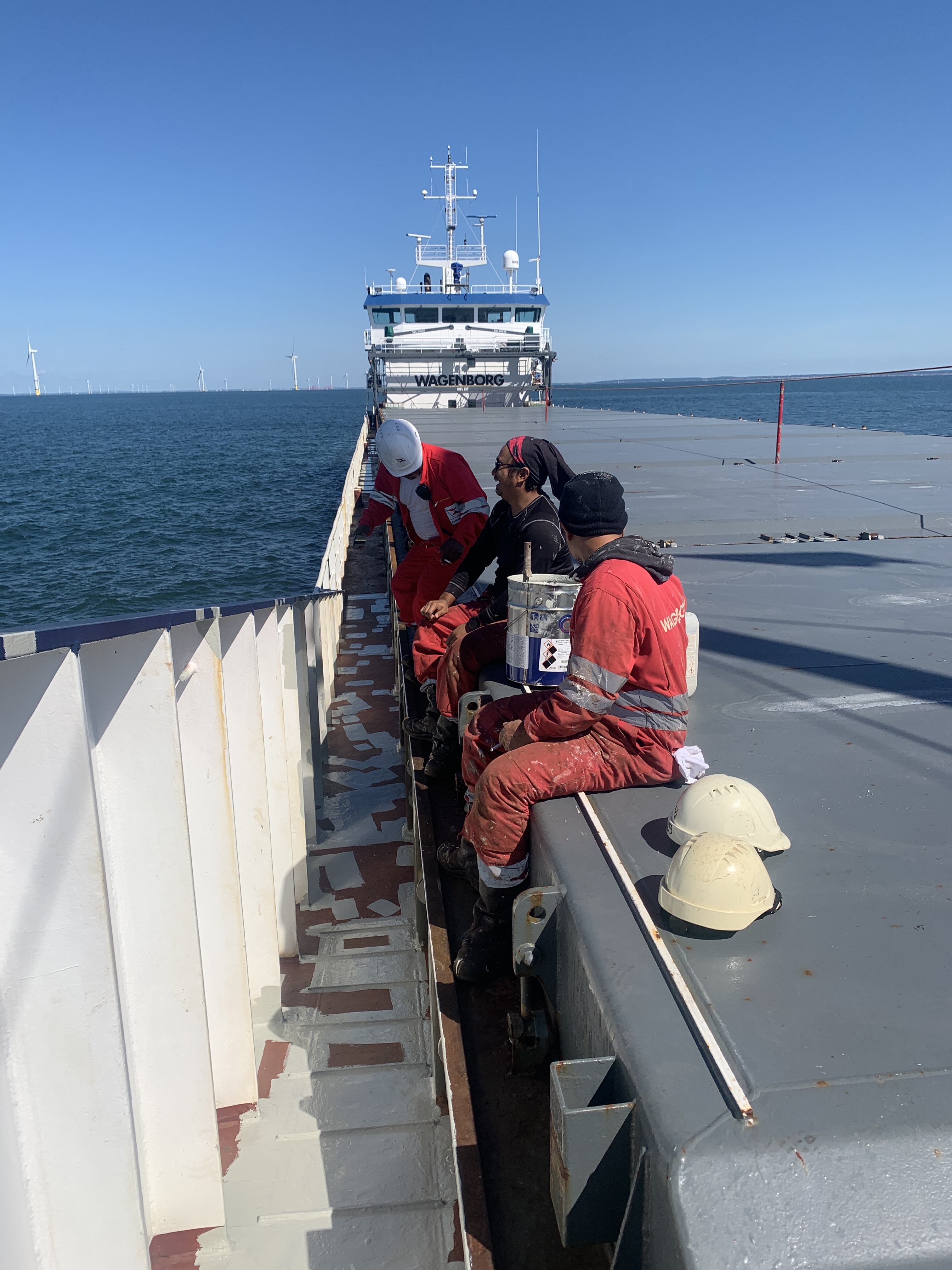 The crew enjoying a sunny day: perfect weather for painting on deck!
